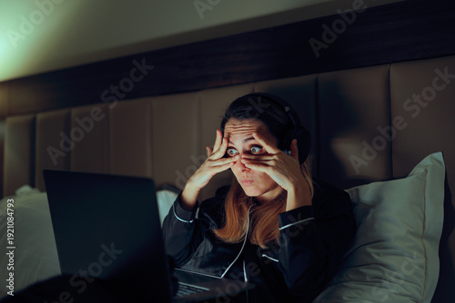 Canvas Print Woman Covers Her Eyes But Can Not Stop Looking at Laptop