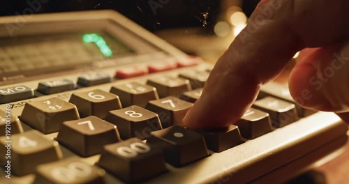 Wallpaper Mural Close-up of a hand pressing buttons on a calculator, with a blurred background of a desk Torontodigital.ca