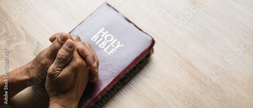 Wallpaper Mural Old man hands clasped prayer with Holy Bible for Christian faith, spirituality, worship, devotion, hope, and religious belief, prayer time in church, trust in God, and spiritual guidance. Torontodigital.ca