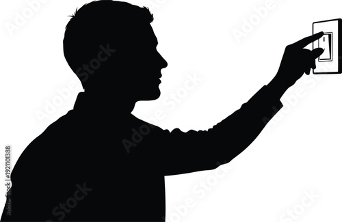 Silhouette of a man turning a light switch