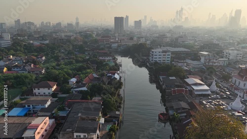 Aerial view morning sunrise with fog river rural village with modern office building background Bangkok Thailand