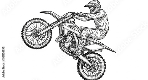 Motocross rider performing a wheelie on a dirt bike.