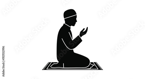 A devout muslim man is kneeling in prayer hands raised in supplication depicted as a striking silhouette