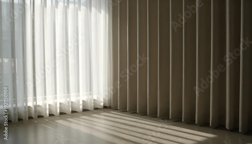 Sunlight streams through sheer curtains casting striped shadows on the floor