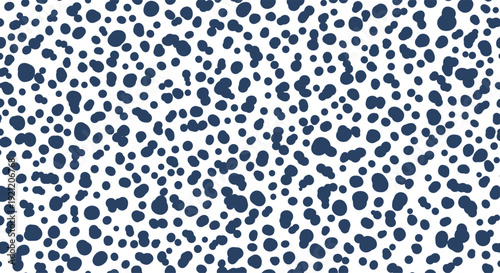 Abstract seamless pattern with random navy blue spots and dots of various sizes on a white background, like an animal print texture.