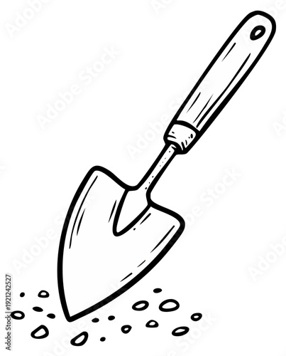 Handheld garden trowel digging into soil with small pebbles for planting and gardening tasks