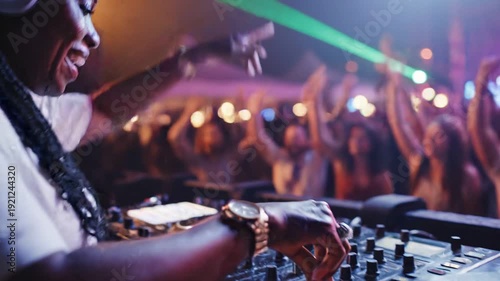 DJ playing music at a lively party with a crowd dancing.