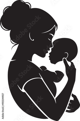 Silhouette of a mother holding and kissing her baby on the cheek in a loving gesture