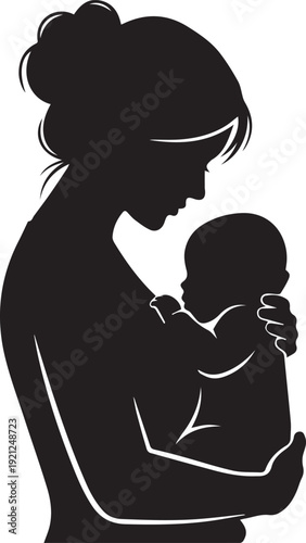 Silhouette of a mother holding her baby in her arms profile view