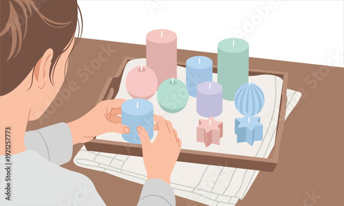 A person arranging colorful handmade candles