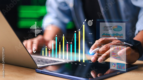 Business analyzing financial data on tablet and laptop with digital charts and growth graph interface. Concept of business analytics, KPI monitoring, investment growth and performance reporting.