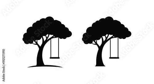 Two trees with swings displayed as a striking black silhouette
