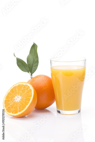 Fresh Orange Juice Glass with Whole and Sliced Oranges
