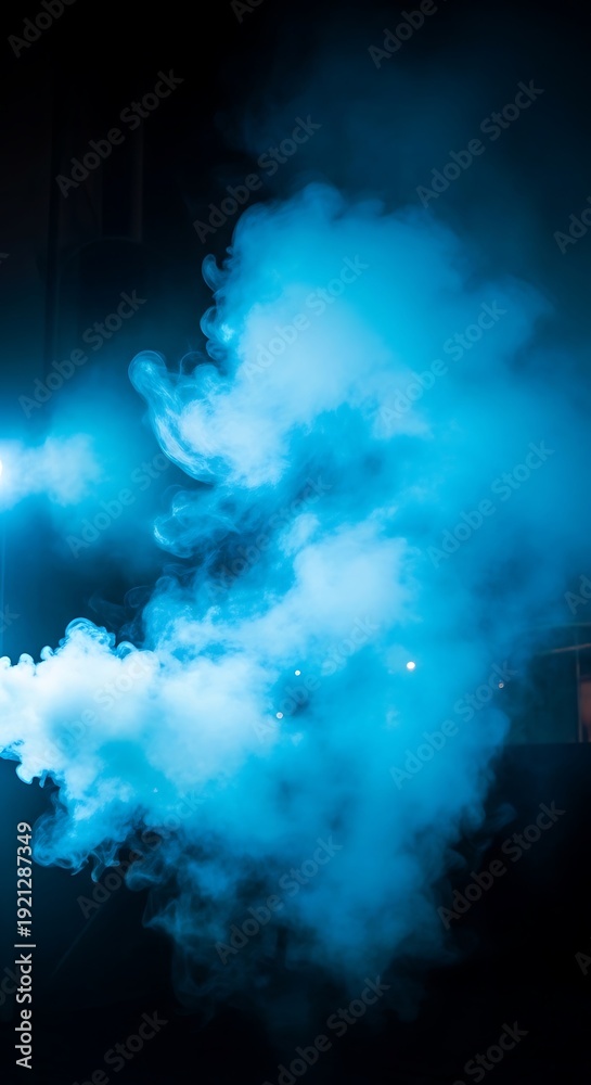 Fototapeta premium Vibrant blue smoke on dark background.