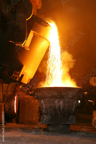 Metal cast process in blast furnace in metallurgical plant or factory. Liquid iron molten metal pouring in container