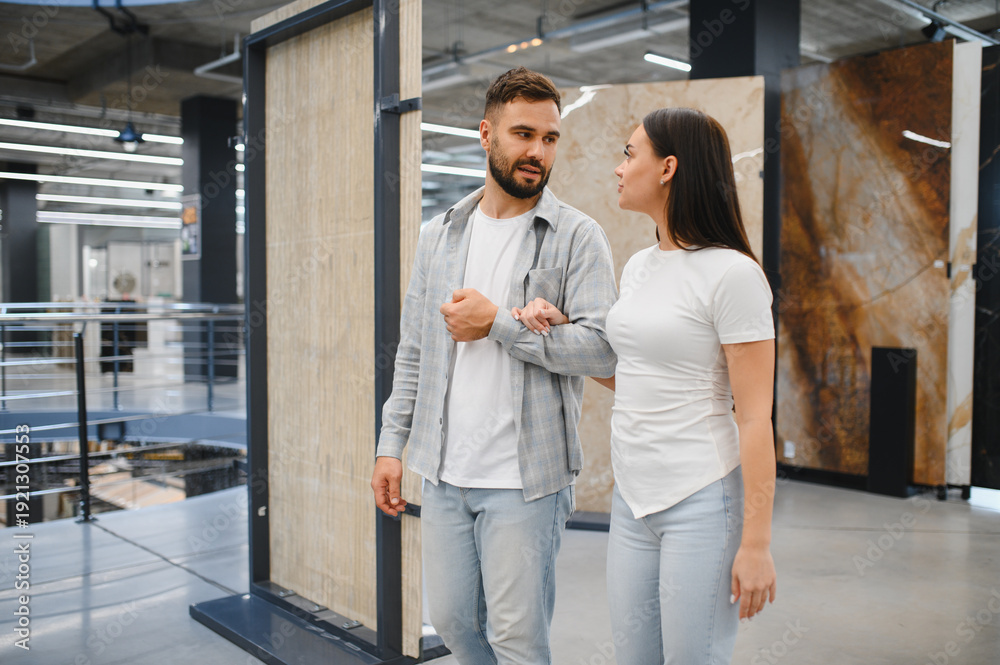 Fototapeta premium Couple choosing floor tiles for home renovation