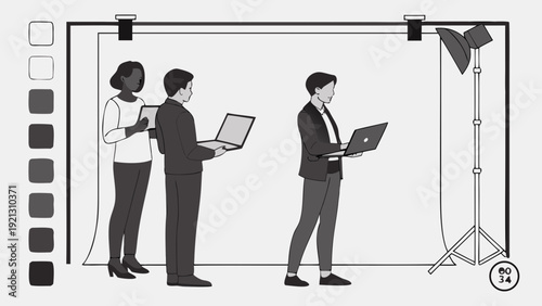 Three people with laptops in a studio setting ready for a photoshoot.