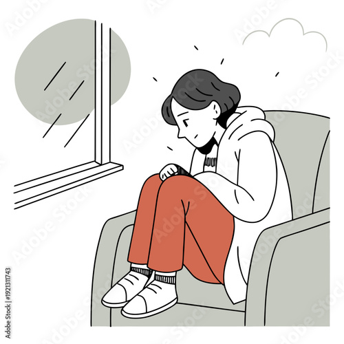 Young woman sitting in an armchair and feeling anxious by the window  