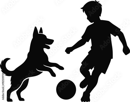 Black silhouette of boy playing soccer with dog