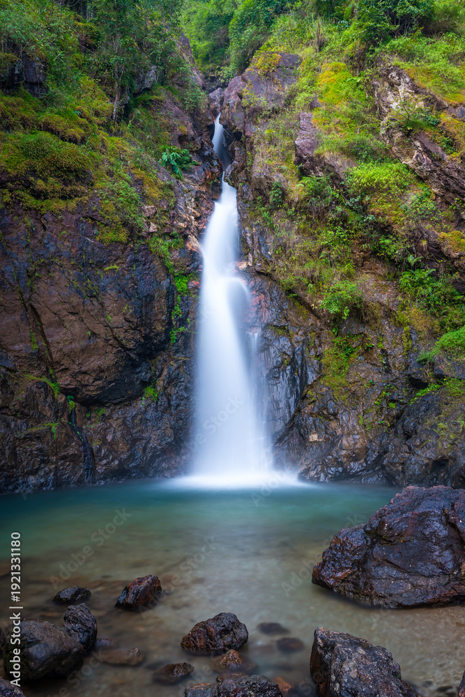 Obraz premium Serene Jokkradin Waterfall in Thong Pha Phum, Kanchanaburi, Thailand flowing into emerald pool