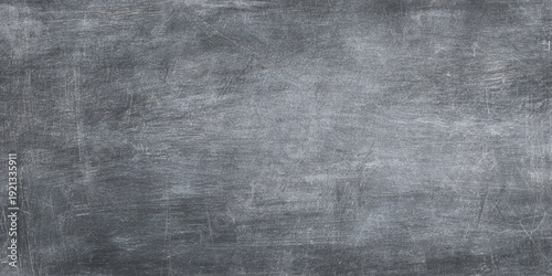 Dark grey concrete wall texture with weathered cement surface includes natural imperfections, cracks, and dark atmospheric stains for urban-style designs, architectural mockups.