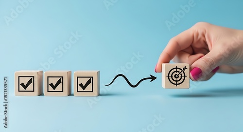Hand moving wooden block with target symbol to checklist blocks
