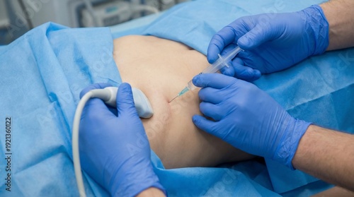 Doctor performing an ultrasound-guided injection or aspiration on a patients body in a clinical setting.