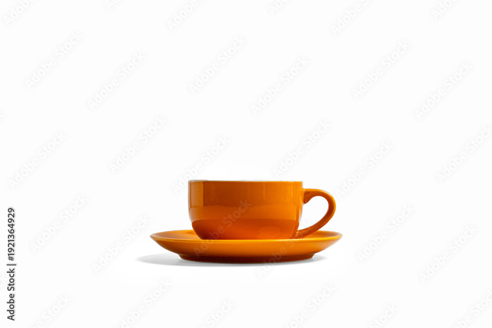 Obraz premium Side view orange coffee cup and saucer isolated on white background