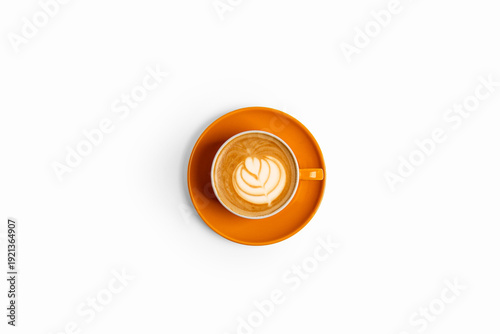 Top view latte art coffee in orange cup and saucer isolated on white background.
