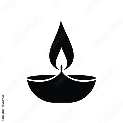 Simple black diya lamp with flame for Diwali or spiritual themes