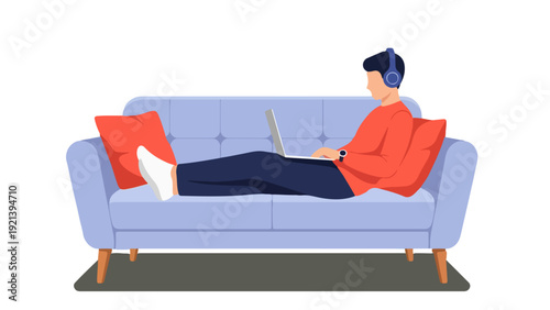 Young Man Working Remotely on Sofa with Laptop and Headphones