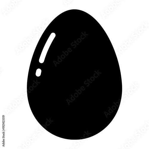 A black egg with a white spot on a white background