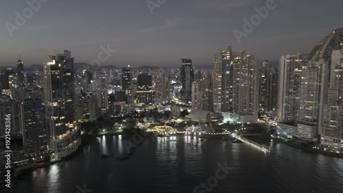 Wallpaper Mural Cinematic aerial drone footage of the sunset over Cinta Costera in Panama City. The golden light of the sunset illuminates the coastal skyline, oceanfront boulevard, and modern buildings of the city,  Torontodigital.ca
