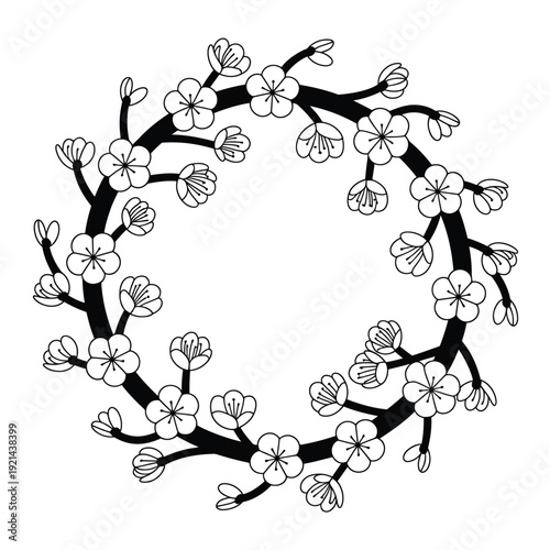 A delicate circular wreath of blossoming branches and small flowers