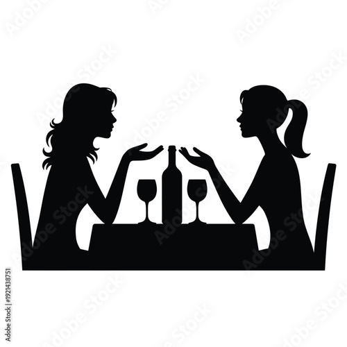 Two women seated at a table engaged in conversation with wine