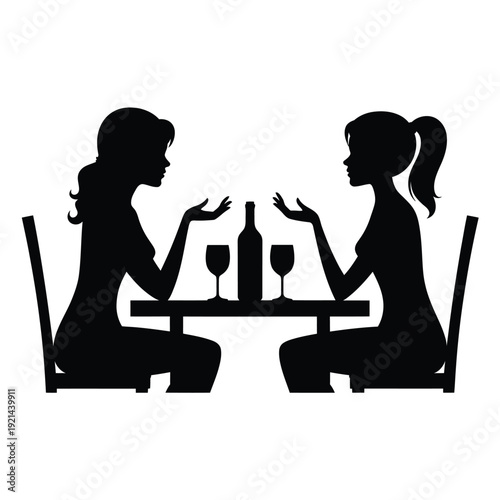 Two women converse across a table with wine glasses and a bottle