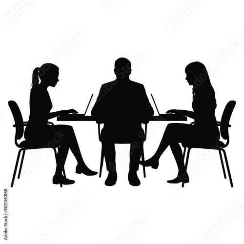 Three people sit at a table working on laptops in silhouette
