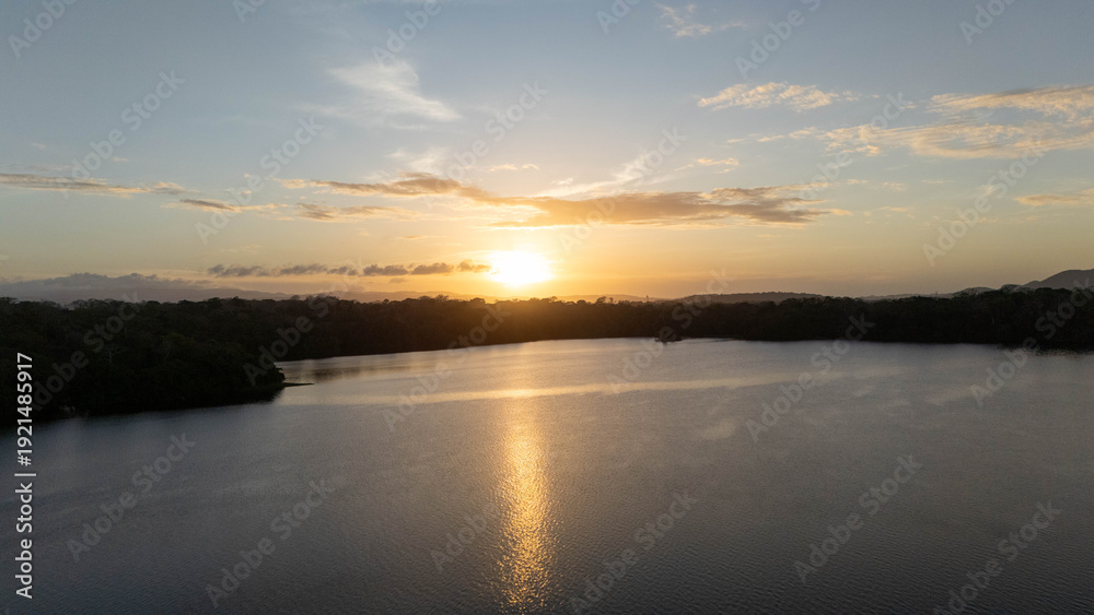 Obraz premium Aerial Sunrise Views of Madden Dam and Alajuela Lake in Chilibre Panama Drone Footage, Cinematic drone footage capturing the sunrise over Madden Dam and Alajuela Lake in Chilibre, Panama. The golden 