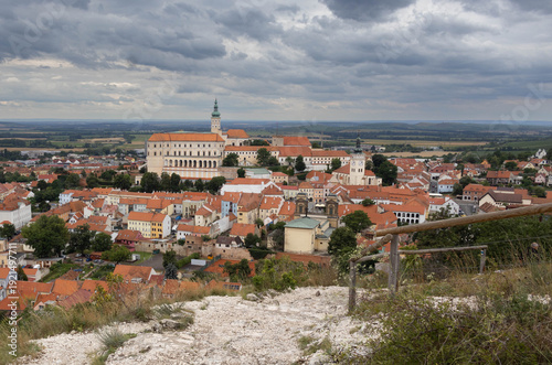 Wide high angle panoramic view from Holy Hill showing the historical town of Mikulov with its dominant castle and red tiled roofs