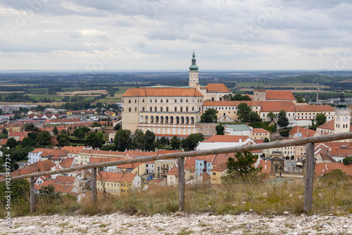 Scenic overlook from the path on Svaty Kopecek hill featuring the monumental Mikulov Castle and the surrounding picturesque landscape of South Moravia