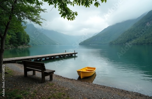 Tranquil lake waters edged by forested mountains under a cloudy sky. A wooden pier with a yellow boat and bench offers peaceful scenery for calm reflection and quiet travel.