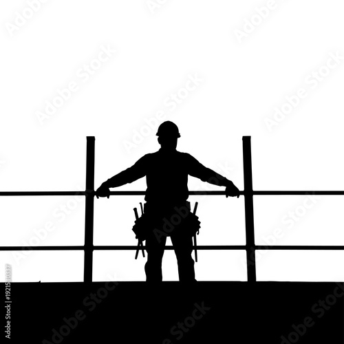 Silhouette of a construction worker standing on a building, arms outstretched.