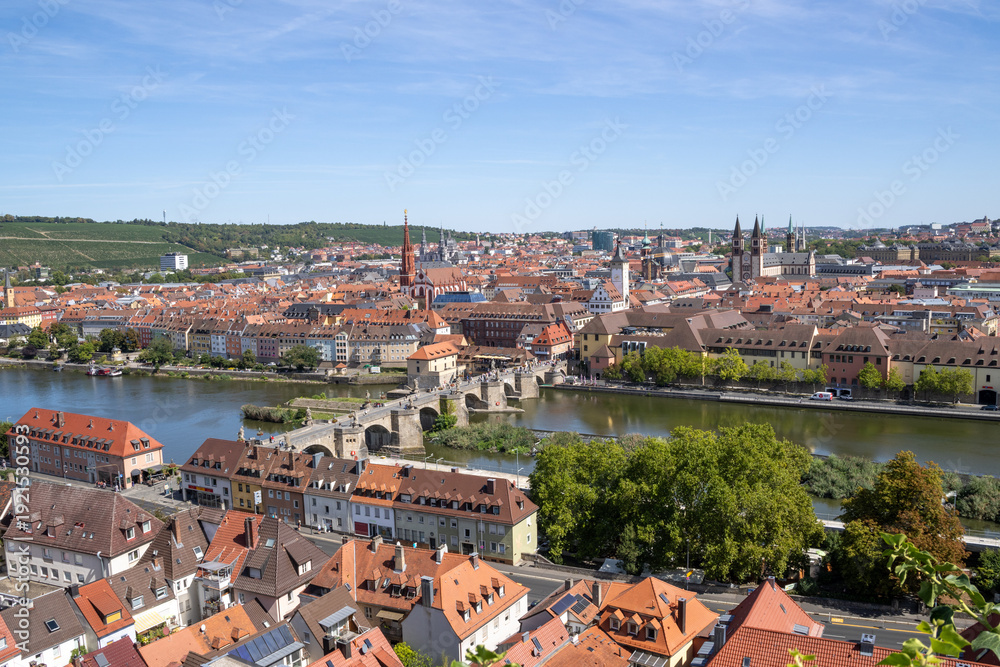 Obraz premium Panoramic view from Festung Marienberg overlooking Würzburg’s historic old town, the Main River and the iconic Old Main Bridge lined with monumental statues.