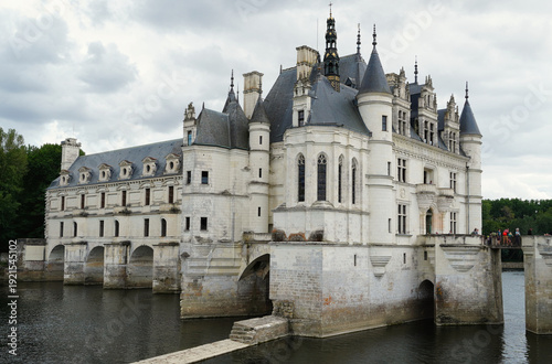 Scenic view of the Château de Chenonceau spanning the River Cher. Iconic French Renaissance architecture with elegant arches, historic galleries, and landscaped surroundings in the Loire Valley