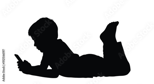 Silhouette of a child lying down and using a mobile phone
