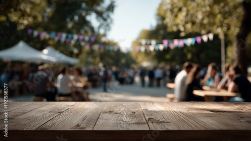 Wooden tabletop at outdoor event with people enjoying festival atmosphere