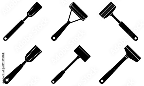 Collection of various paint rollers and brushes arranged in a circular pattern on a clean surface