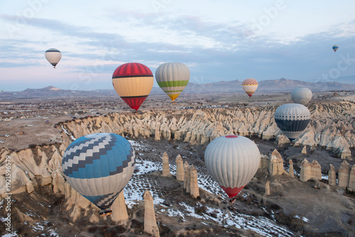 Wallpaper Mural Panoramic landscape view across Cappadocia region valley with fairy chimneys and hot air balloons flying in sky Torontodigital.ca