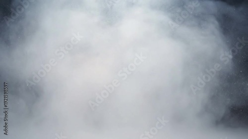 Golden Hour Haze Loop A tranquil scene with golden hour sunlight piercing through a thick layer of fog, illuminating countless dust motes with a warm, gentle glow, creating a continuously looping,