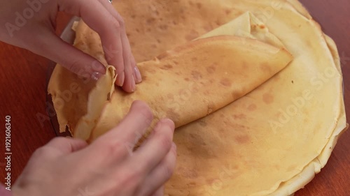 A woman is preparing juicy pancakes with mushrooms.